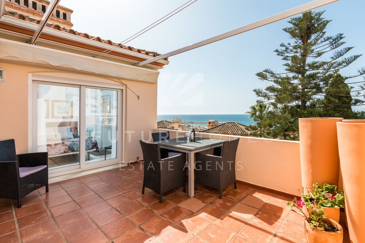 Superb penthouse apartment next to Estepona port with large open wrap around terrace.