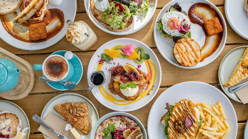 a spread of different brunch foods, featured image for the article 'Discover The Best Brunch Spots on the Golden Mile'