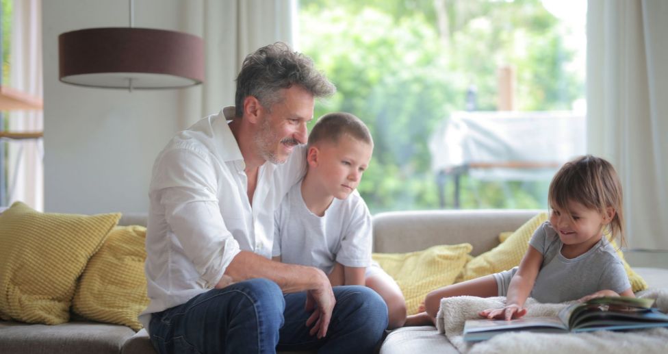 Father playing with children at home