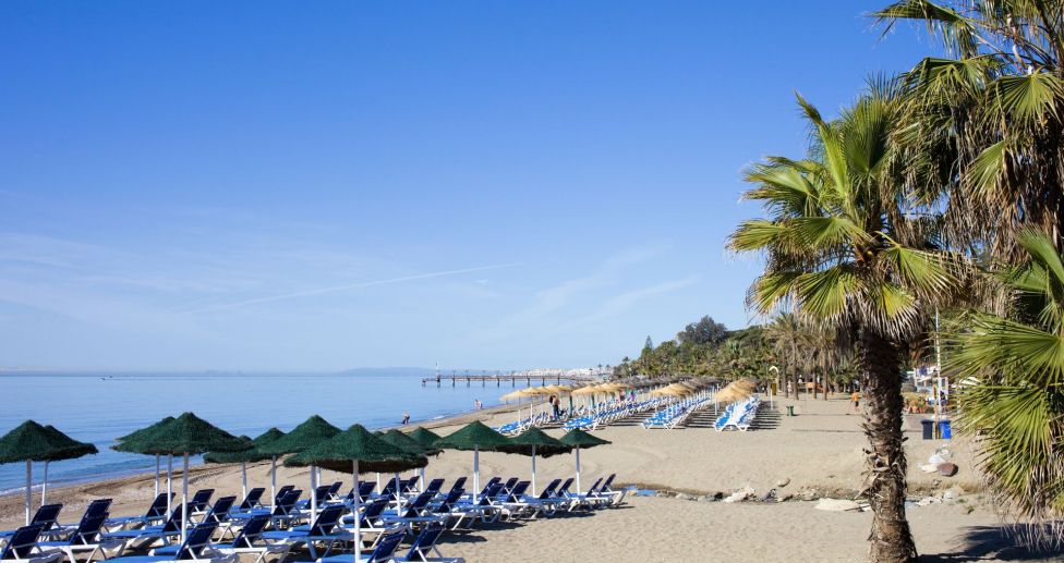 Beach with sunbeds on Marbella Golden Mile near La Carolina area