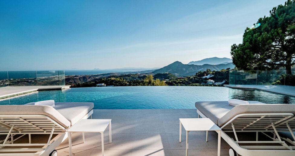 Pool and sun loungers overlooking the Mediteranean sea in a luxury property for sale in Marbella