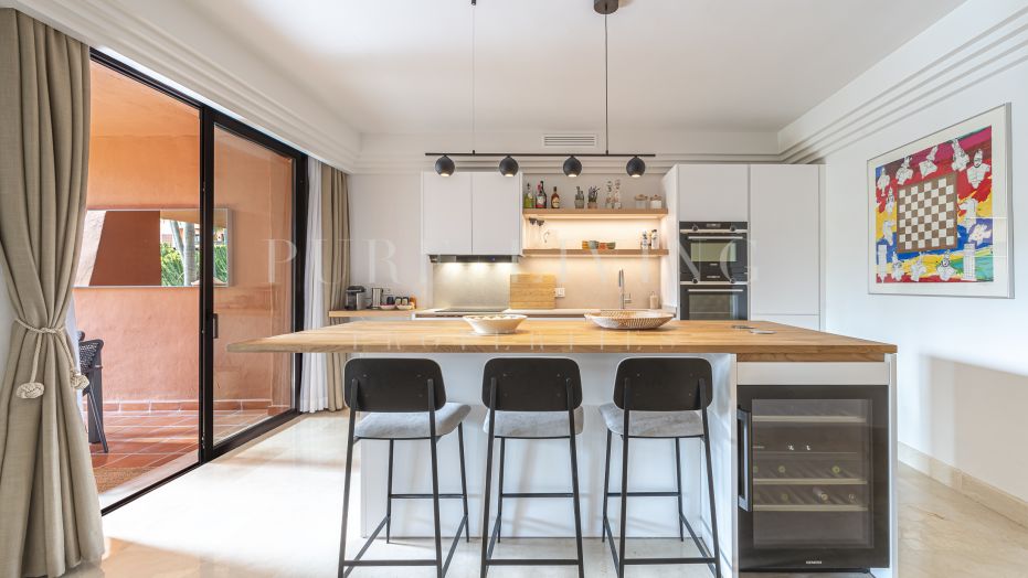 A spacious four bedroom garden apartment in the gated community of La Alzambra.