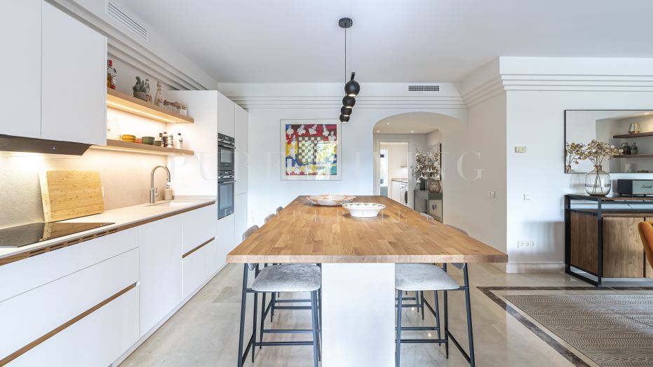 A spacious four bedroom garden apartment in the gated community of La Alzambra.