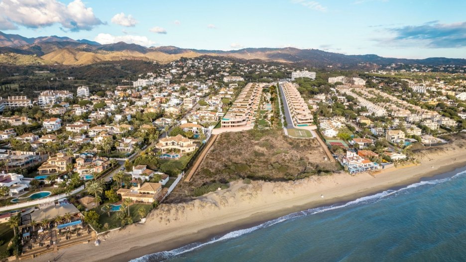 Aerial view of properties in Marbella East, highlighting the coastal landscape and residential areas.