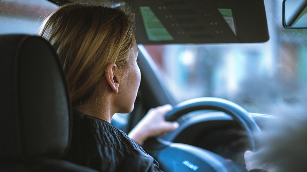 a woman driving, featured image for the article