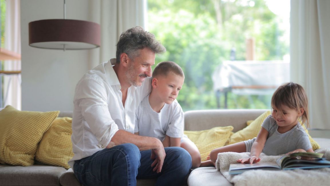 Father playing with children at home