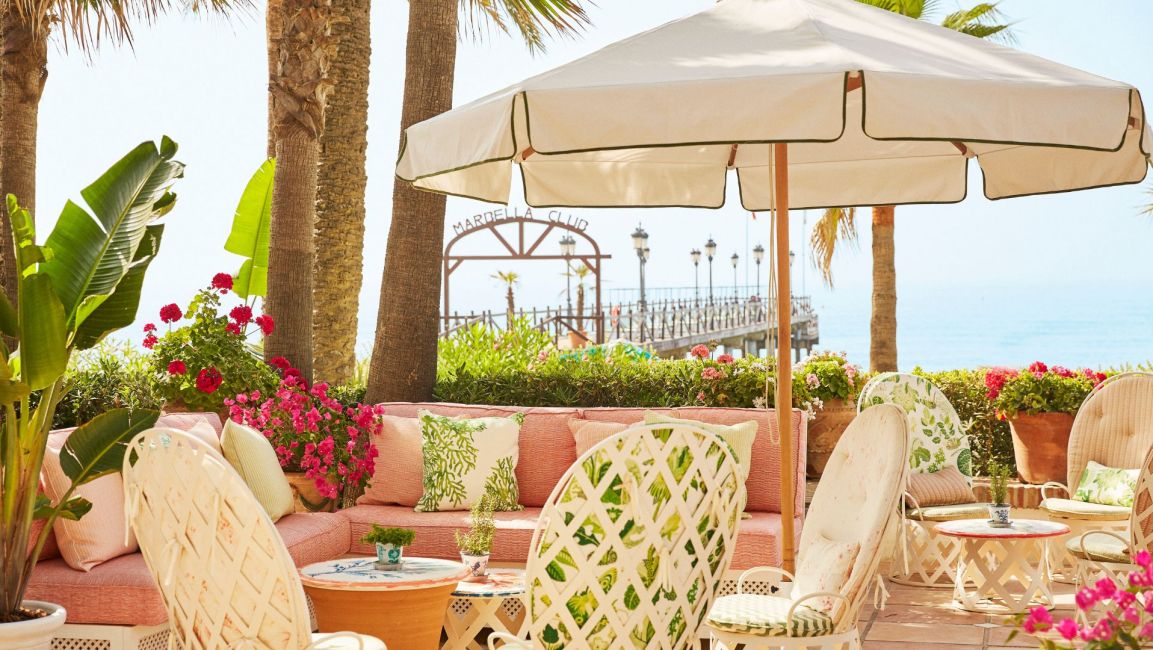 Vintage style table and sun umbrella at Marbella Club Chiringuito on the Golden Mile