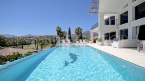 This stunning villa is nestled in a beautiful residential enclave overlooking the popular Los Naranjos Golf of Marbella.