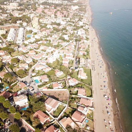 Drone image of Costabella Marbella showing the beautiful beach, luxury properties, and high-end amenities of the community