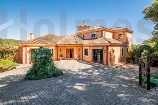 Elegant rustic style villa with great views to La Reserva golf course and the sea in the distance.