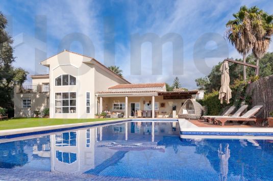 Modern Villa with Stunning Golf Course Views and Unique Cave Feature.