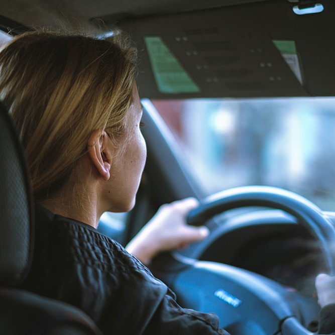 a woman driving, featured image for the article 