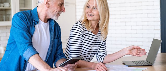 an elderly couple checking documents with a laptop, featured image for 'Unlocking Tax Benefits for Retirees in Spain'