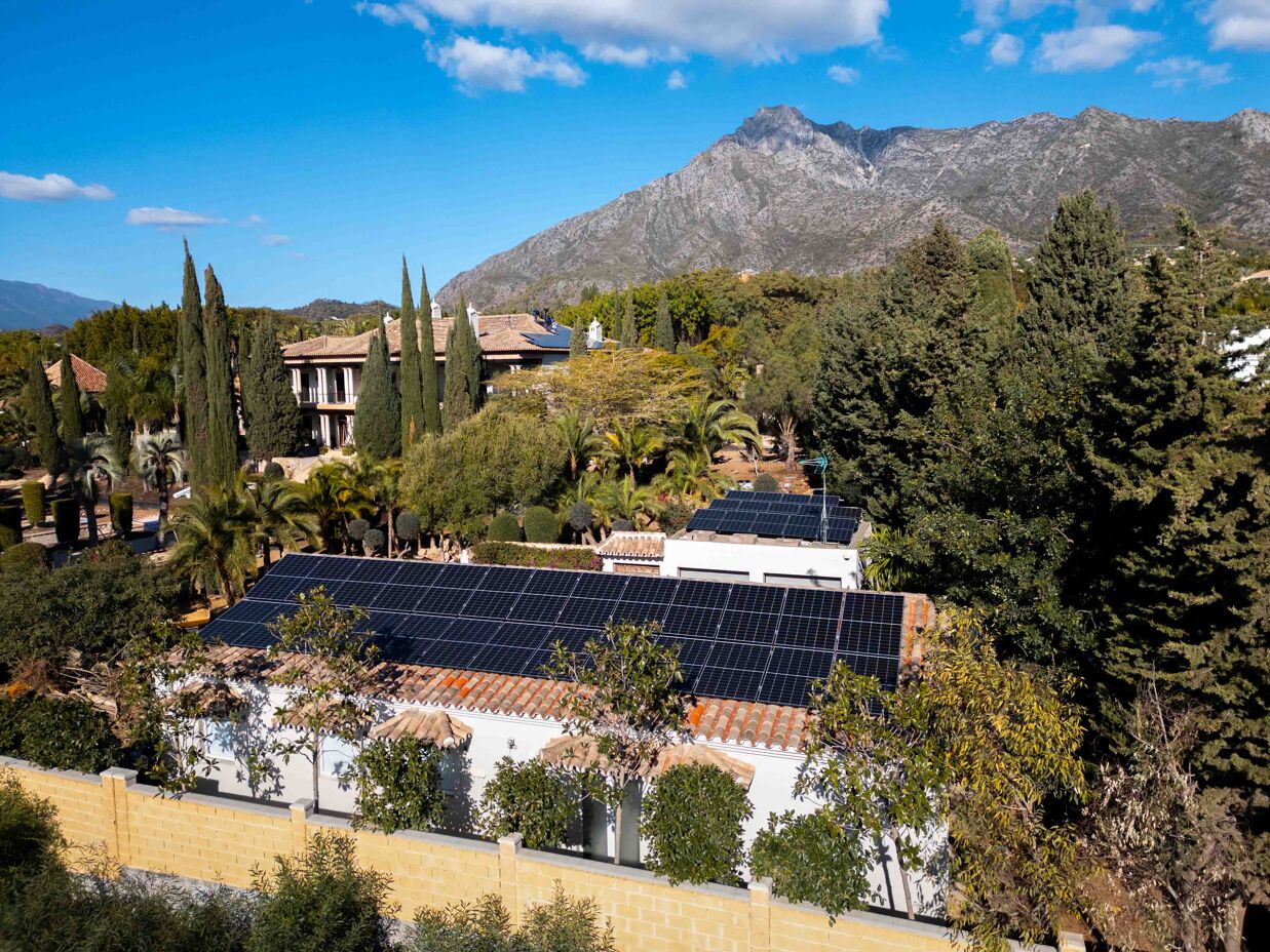 Close-up of architecturally integrated solar panels on a Marbella luxury villa roof, blending energy efficiency with design.