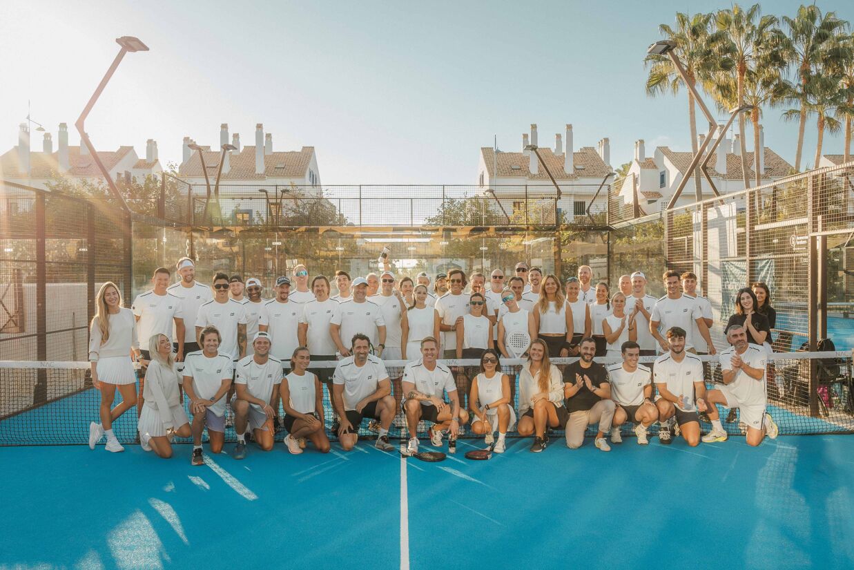 Group photo of players and guests at the Homerun Brokers x Range Rover padel tournament in Marbella.