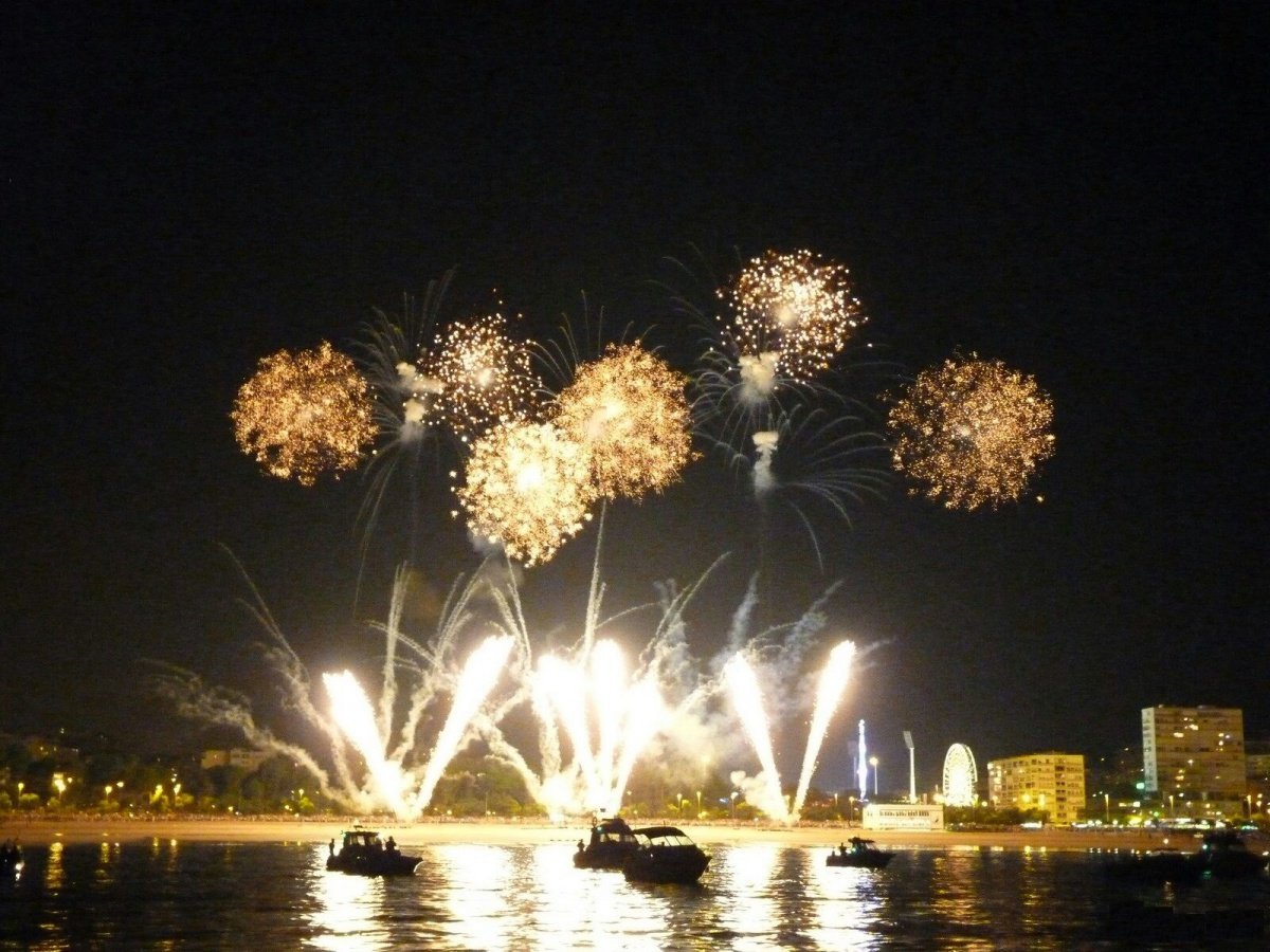 Marbella coastline at night with fireworks reflecting over the Mediterranean Sea on New Year’s Eve