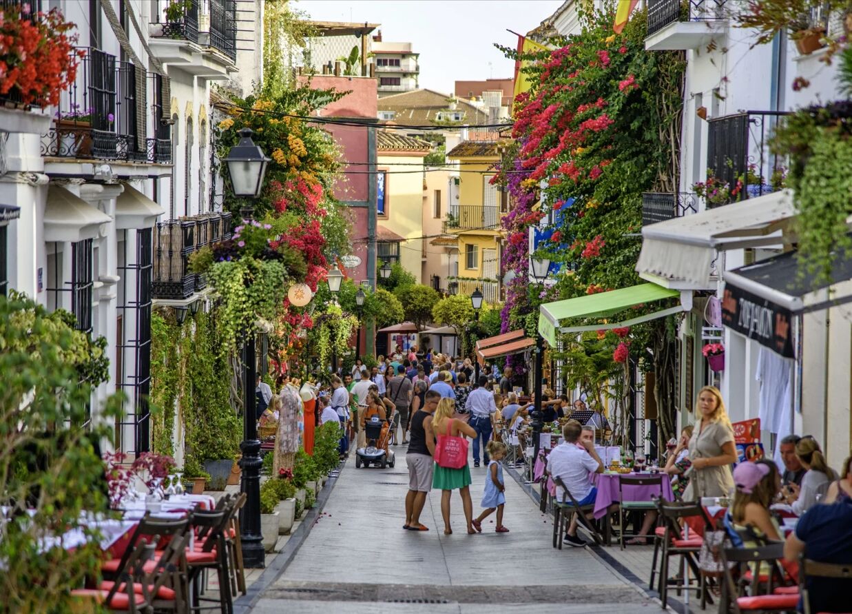 Colorful street in Marbella Old Town with flowers and local shops