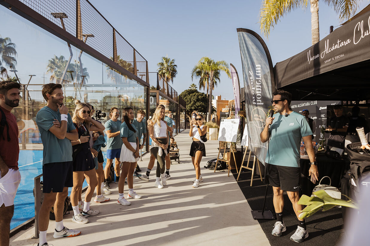 Players and guests listening to the welcome speech at Homerun Brokers' annual padel tournament in Marbella.