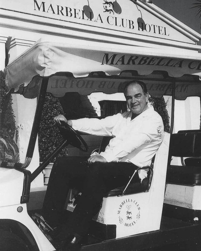 Count Rudi infront of Marbella Club Hotel on a golf buggy