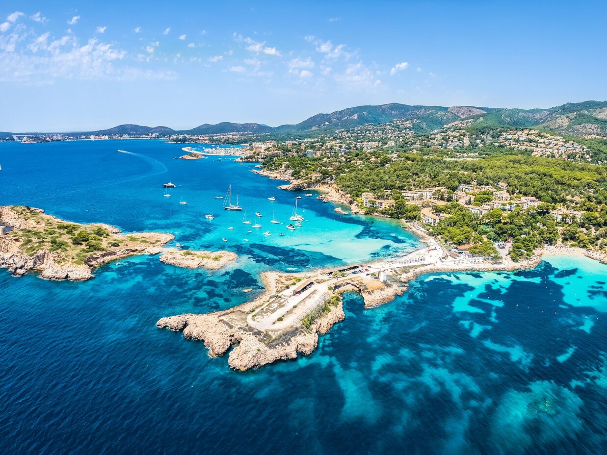 Aerial view of luxury villas on Mallorca’s coastline overlooking the Mediterranean Sea.