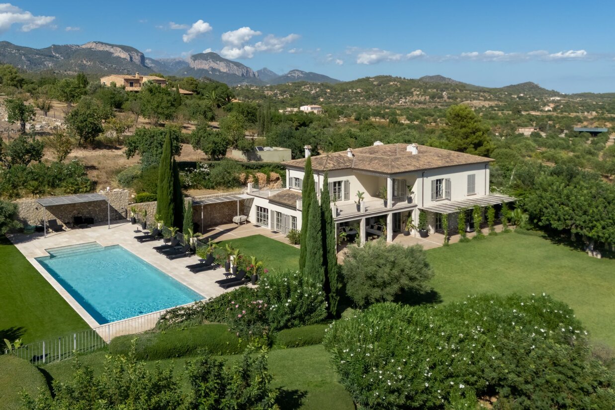 Exterior view of Finca Santa Maria villa in Santa Maria del Camí, Mallorca, showing modern architecture and Mediterranean landscape.