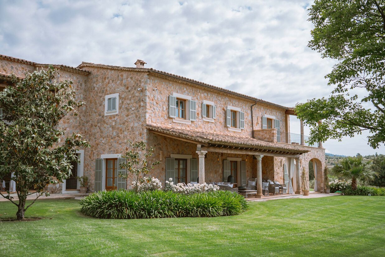 Mallorca’s architecture blends effortlessly into its landscape - sun-warmed natural stone facades and green windows reflecting the nature that surrounds them