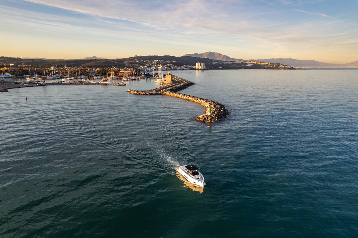 Sotogrande marina at sunset with luxury yachts, calm water reflections, and Mediterranean lifestyle atmosphere.
