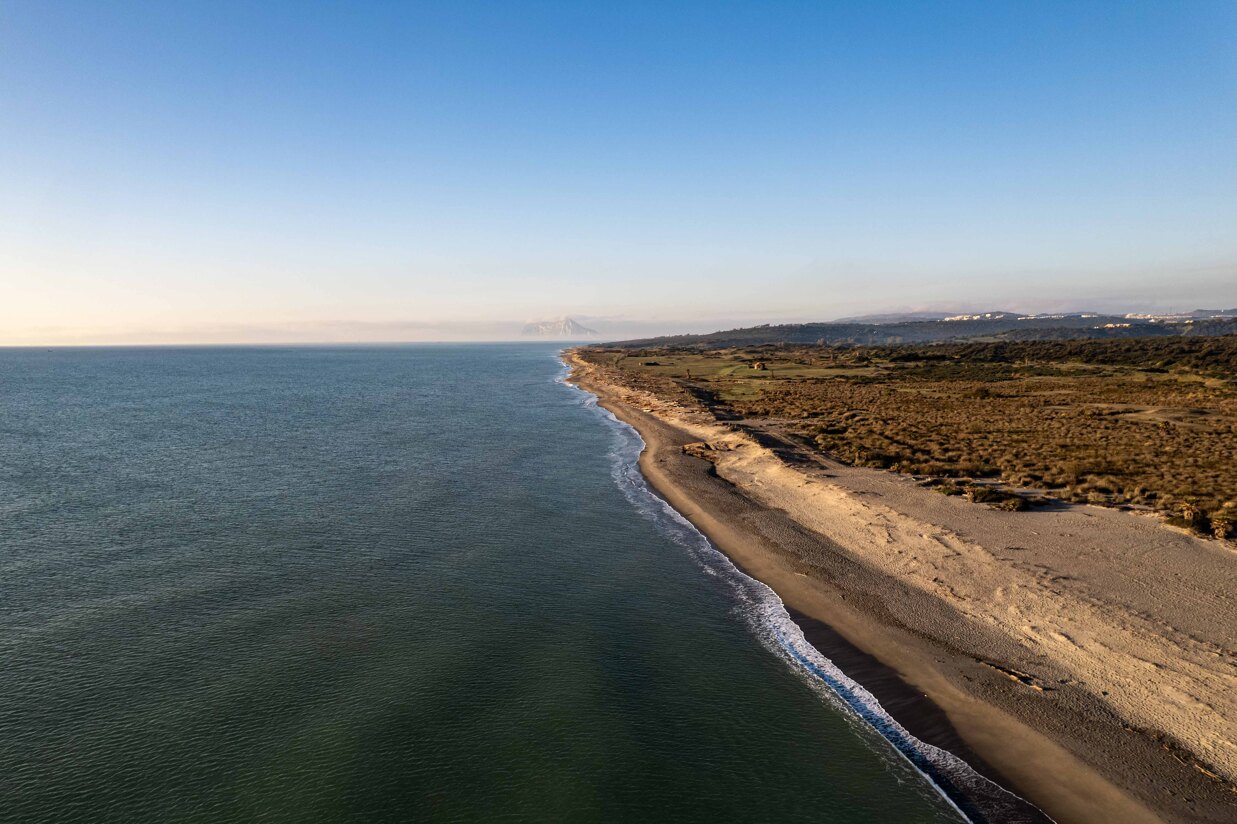 Aerial view of the Sotogrande coastline showing natural beaches and surrounding Mediterranean landscape.