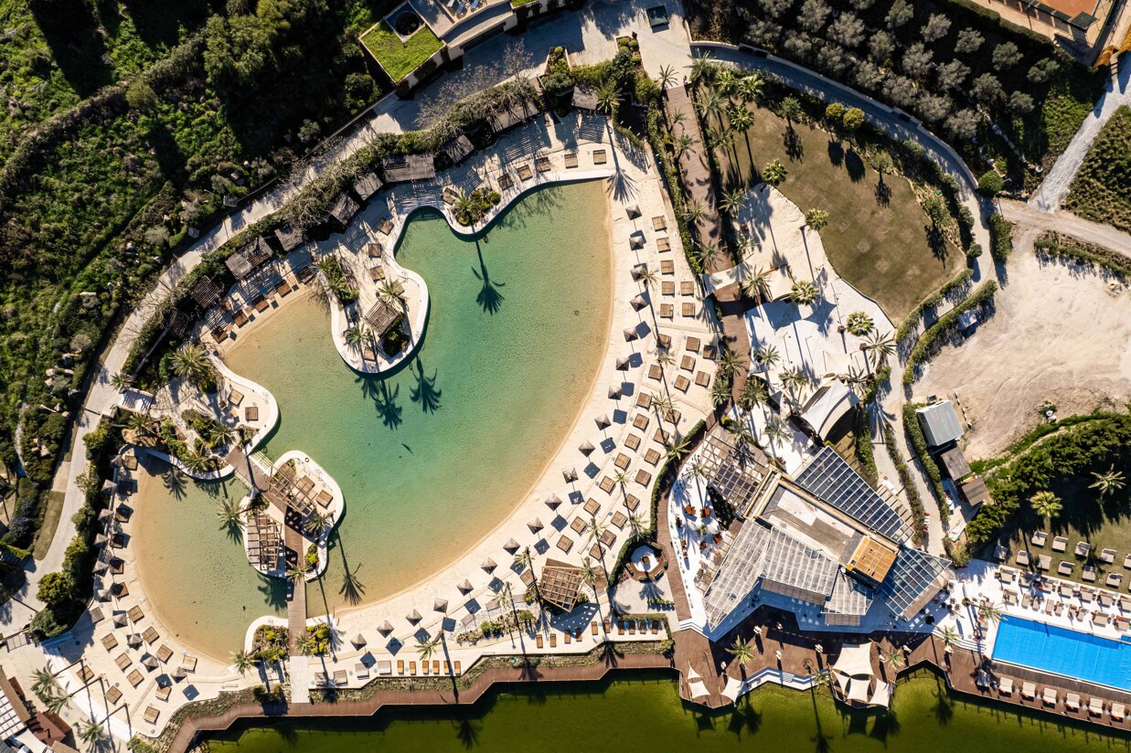 La Reserva Beach lagoon club in Sotogrande with sandy pool, sunbeds and leisure facilities.