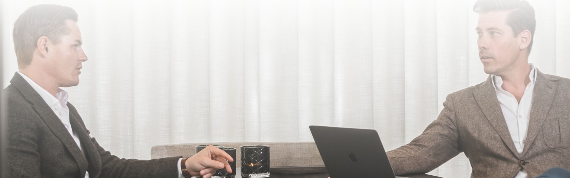 Roger and Eric, partners at Homerun Brokers in a meeting.