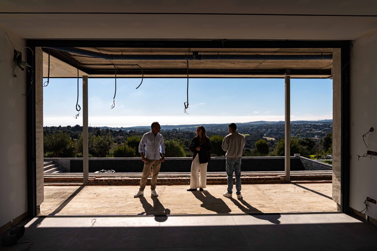 Our agent Liam and the marketing team carefully examining a Sotogrande property with panoramic sea and mountain views, discussing its condition and marketing strategy before its exclusive public launch.