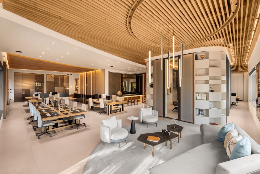 Inside Drumelia – panoramic view of Marbella office with open-plan desks, lounge area, and curved wooden ceiling design