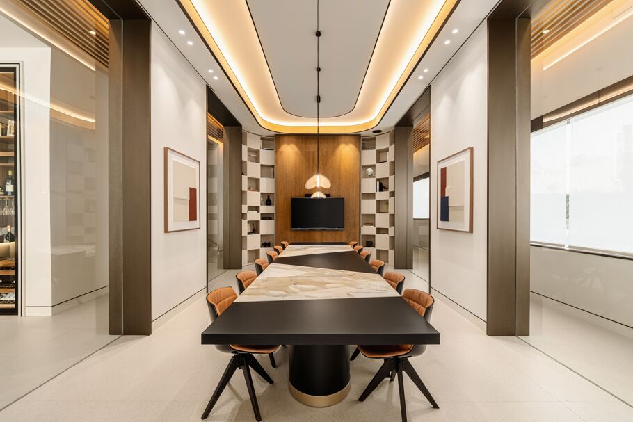 Inside Drumelia – luxury meeting room in Marbella office with marble conference table, designer lighting, and modern wall art