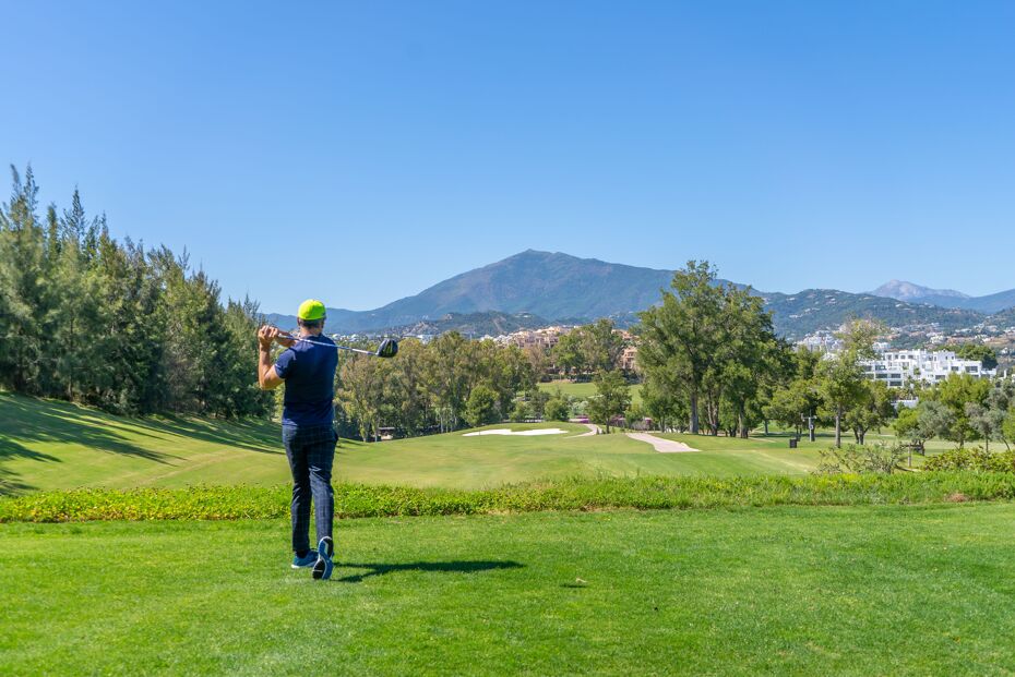 Photograph of a man playing golf in Marbella on a warm summers day