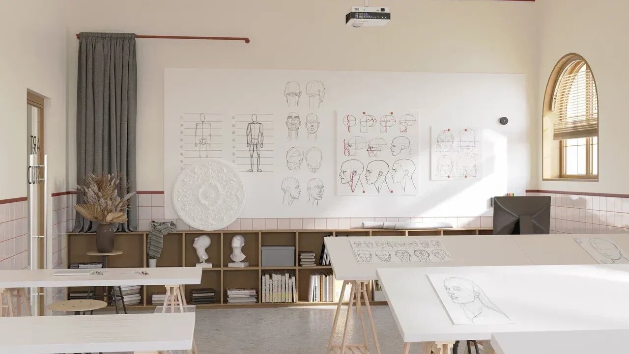 Art school classroom in Benahavís with drawing boards, anatomical sketches on the wall, and natural light from arched windows.