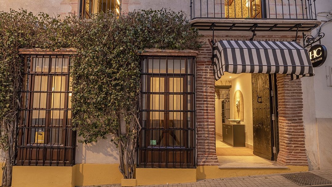 An old Andalusian-style house with a balcony and climbing vines in the heart of Marbella's old town.