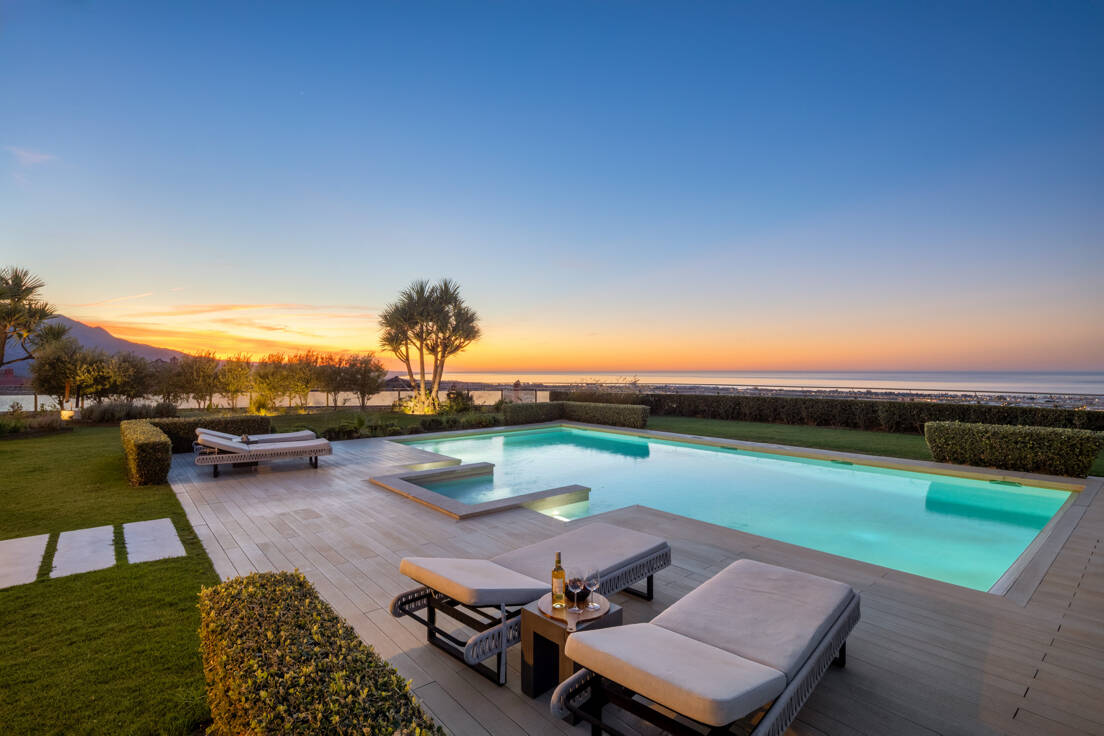 Sea views from a luxury villa in Marbella at the sunset with modern pool and sunbeds