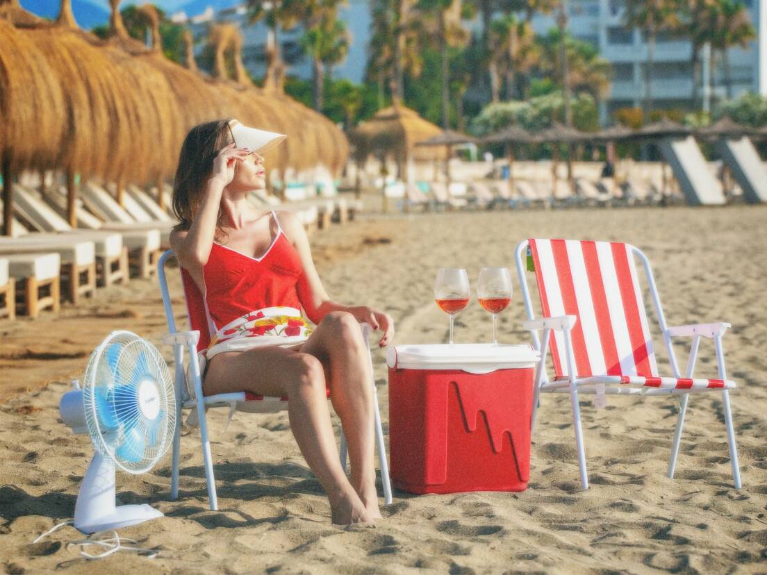 Woman on the beach with red costume and red chair