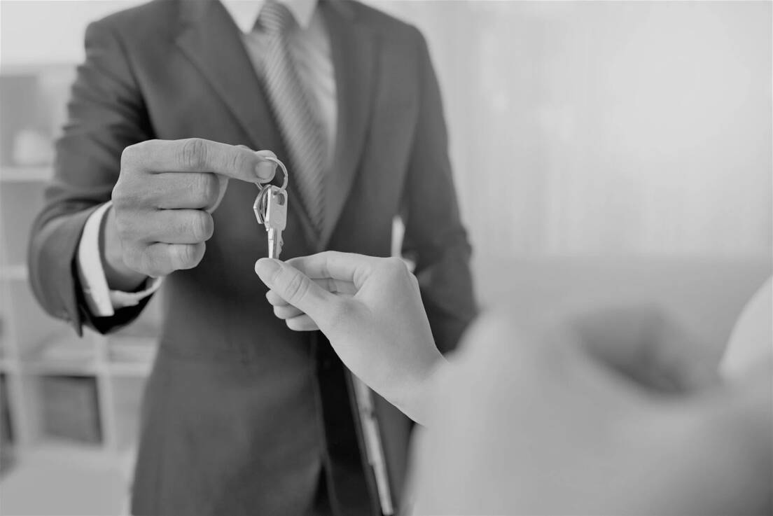 Real estata agent giving the keys of the house to an owner