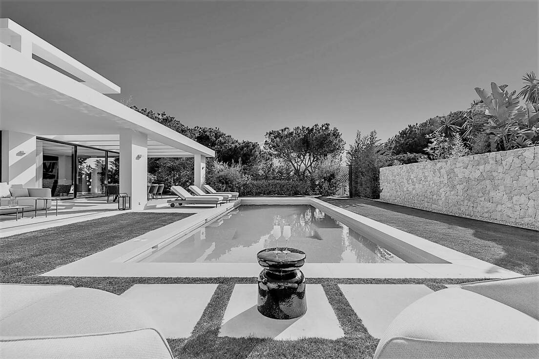 Outdoor space of a luxury property with manicured garden and well maintenance pool