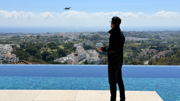 Luxury real estate marketing in Marbella featuring aerial drone filming over a contemporary villa with panoramic sea views, highlighting premium property presentation and high-end visual storytelling by Marbella Hills Homes.
