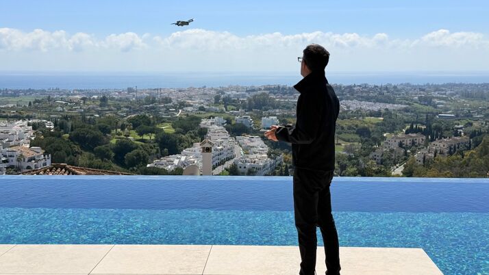 Luxury real estate marketing in Marbella featuring aerial drone filming over a contemporary villa with panoramic sea views, highlighting premium property presentation and high-end visual storytelling by Marbella Hills Homes.
