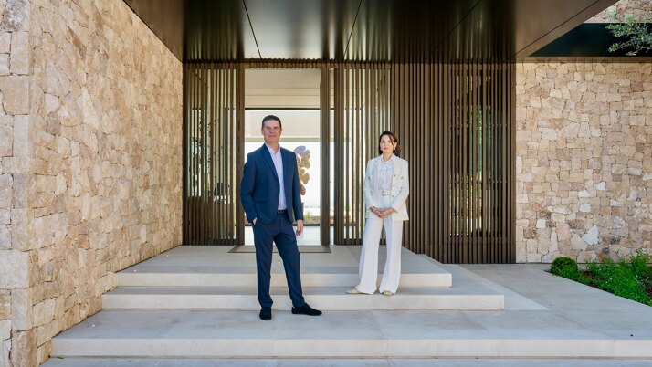 Founders of Marbella Hills Homes, Frédéric Bentz and Evelin Bentz, standing at the entrance of a contemporary luxury villa in Marbella, representing a boutique real estate advisory specialised in prime and ultra-luxury properties.