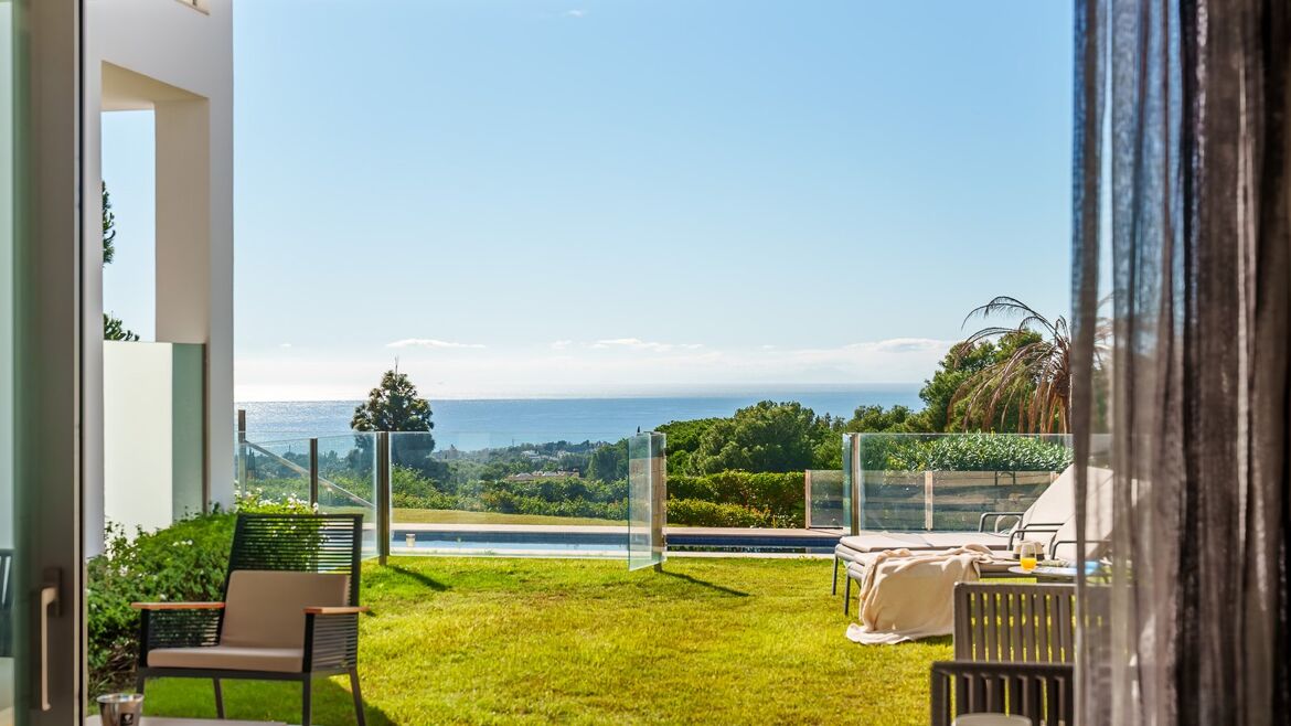 Living room opening onto the garden with sea views in Vistas Marinas