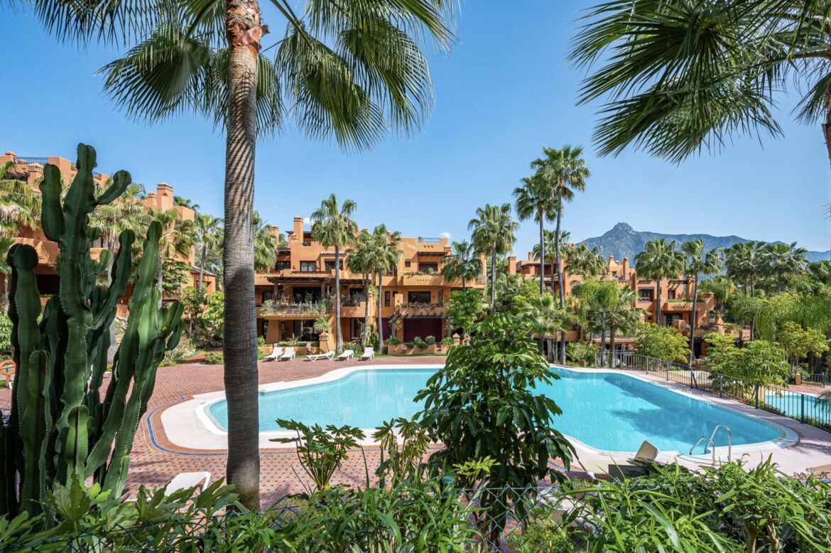 La Alzambra Hill Club communal pool and gardens with La Concha mountain behind