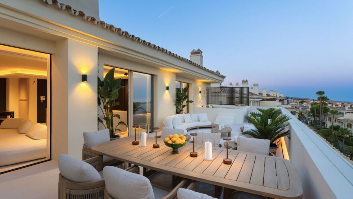 Penthouse terrace at dusk in Condado de Sierra Blanca, Marbella