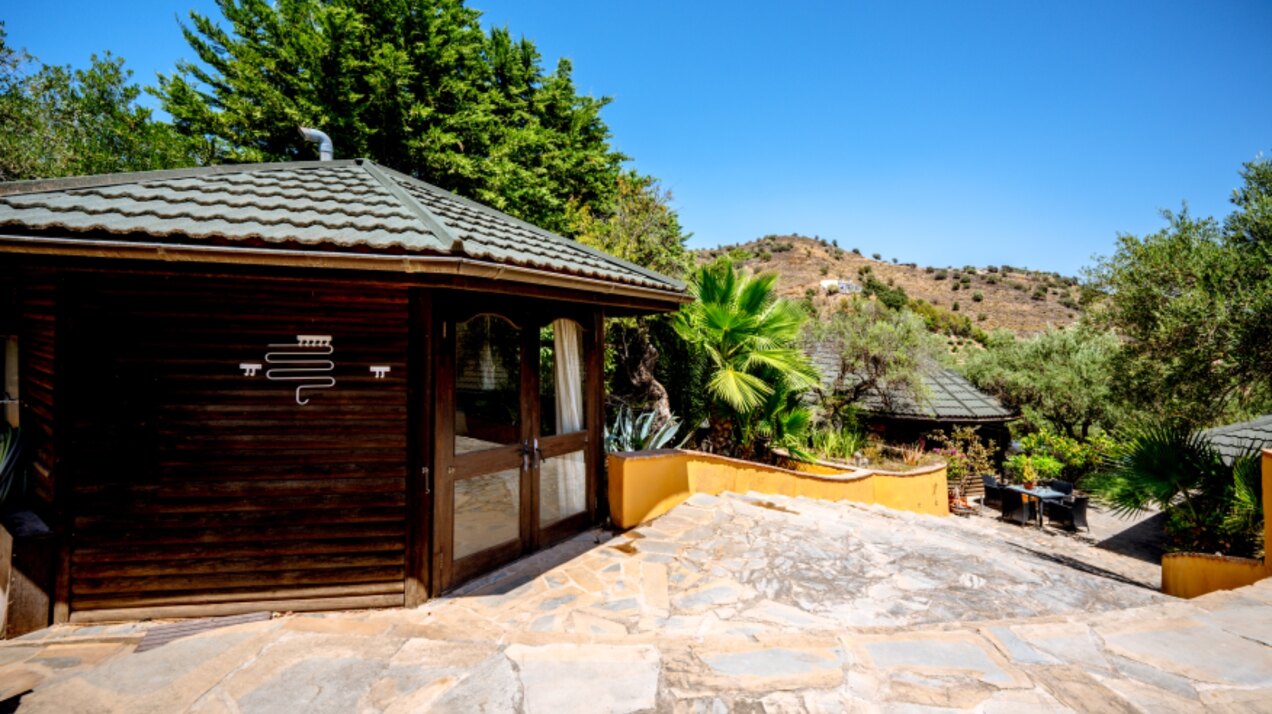 Stunning wooden country finca sits on the outskirts of Monda and its historic castle