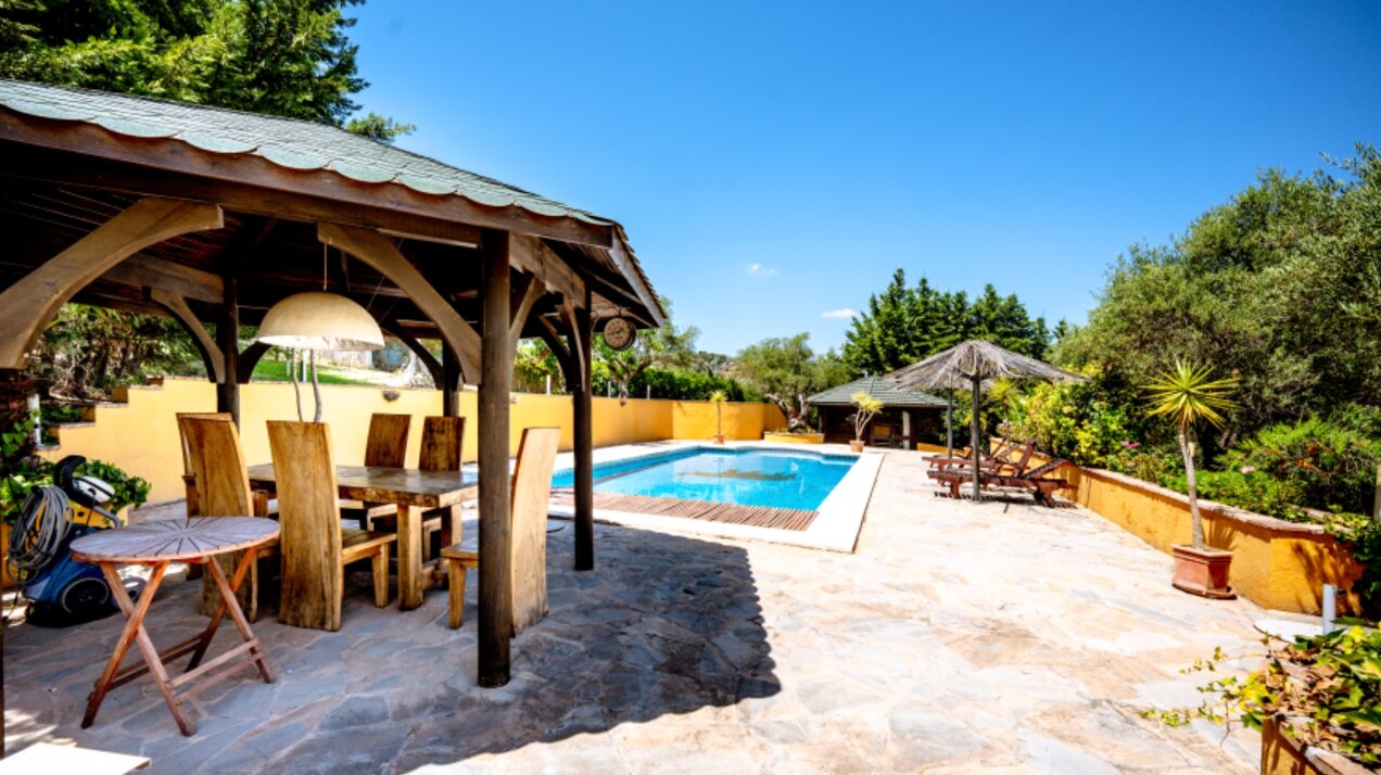 Stunning wooden country finca sits on the outskirts of Monda and its historic castle