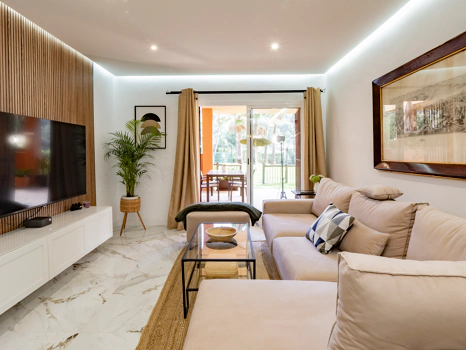 Recently renovated ground floor apartment with private garden in La Reserva de Marbella, front line golf, terrace, and communal pool.