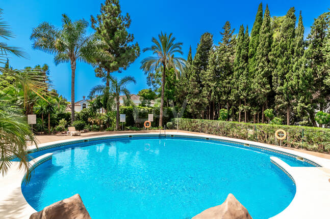 Charming Garden Apartment with Direct Pool Access in Gated Community